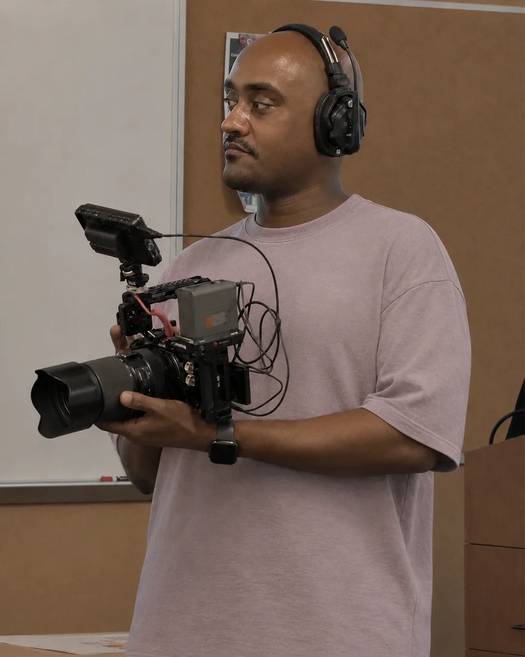 Ahmed Mohamed holding a professional cinema camera during a video production